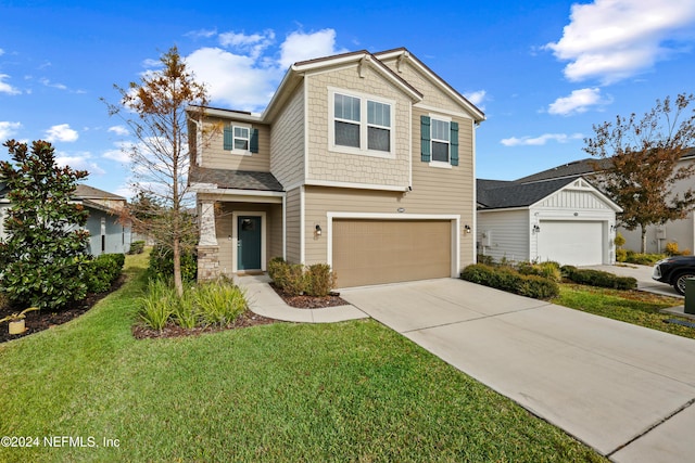 view of front facade with a garage and a front lawn