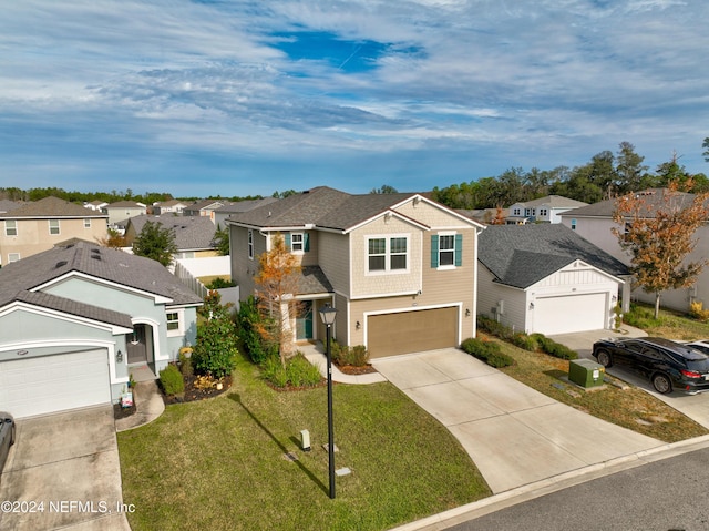 view of front of house with a front yard and a garage