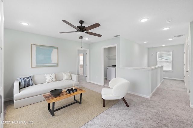 carpeted living room with ceiling fan