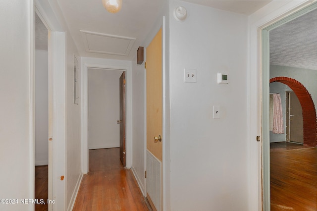 corridor with light hardwood / wood-style flooring