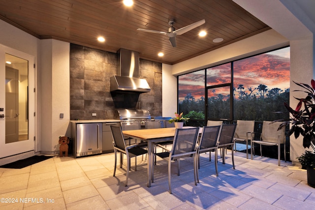 patio terrace at dusk with a grill and ceiling fan