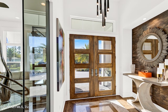 foyer entrance featuring hardwood / wood-style floors, a healthy amount of sunlight, and french doors