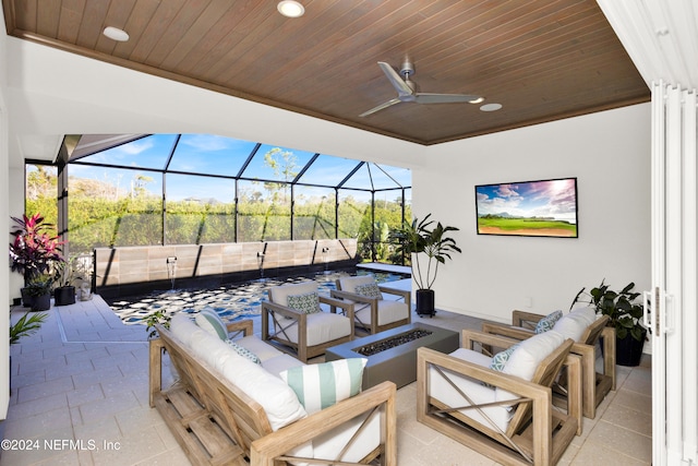 view of patio with glass enclosure, ceiling fan, and an outdoor hangout area