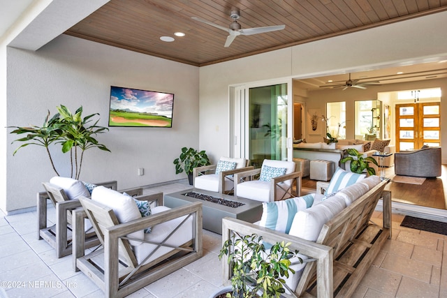 view of patio / terrace with an outdoor living space with a fire pit and ceiling fan