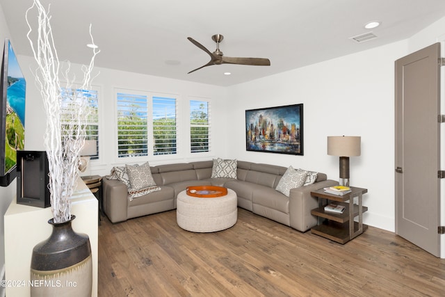 living room with hardwood / wood-style flooring and ceiling fan