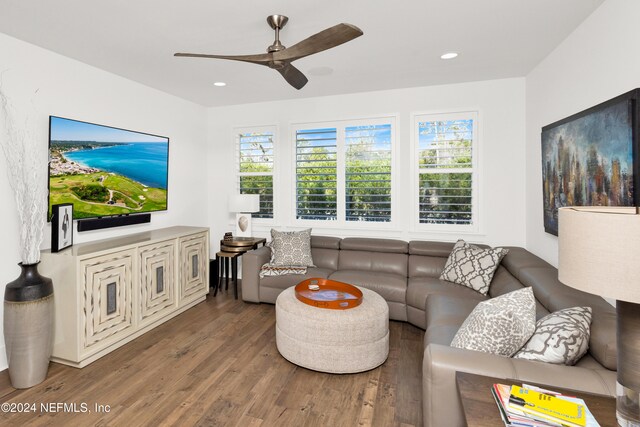 living room featuring hardwood / wood-style flooring and ceiling fan