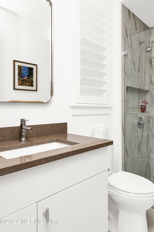 bathroom with vanity, toilet, and an enclosed shower