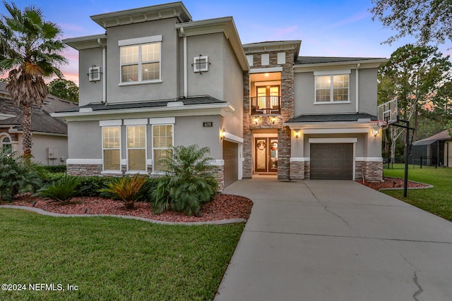 view of front of house with a garage and a lawn