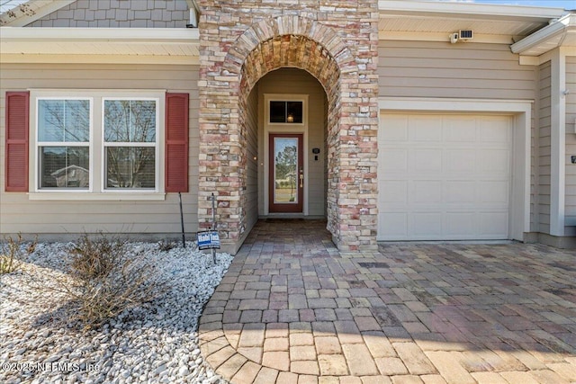 doorway to property featuring a garage