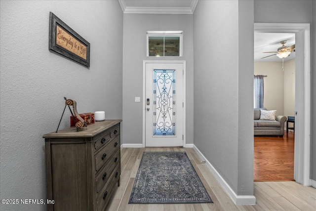 foyer featuring crown molding and light hardwood / wood-style floors