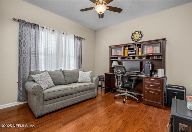 office featuring hardwood / wood-style flooring, ceiling fan, and a textured ceiling