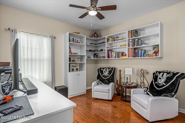 office area featuring hardwood / wood-style flooring, ceiling fan, and a textured ceiling