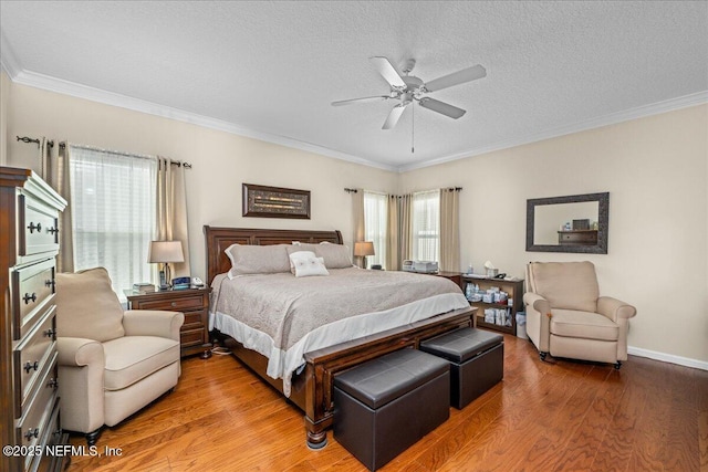 bedroom with hardwood / wood-style flooring, crown molding, a textured ceiling, and ceiling fan