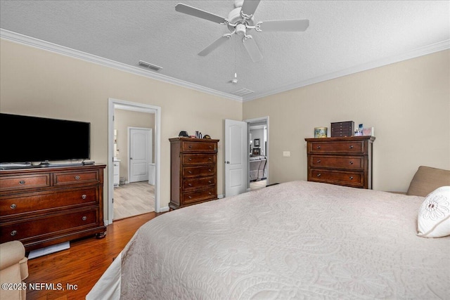 bedroom featuring crown molding, a textured ceiling, ceiling fan, and light hardwood / wood-style floors