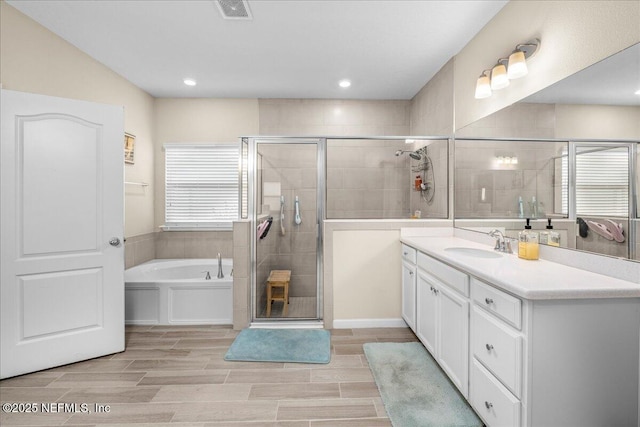 bathroom with vanity and plus walk in shower