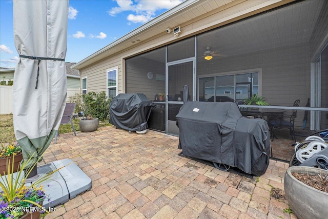 view of patio / terrace featuring grilling area and a sunroom