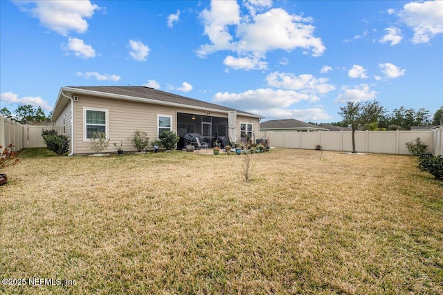 rear view of house with a yard