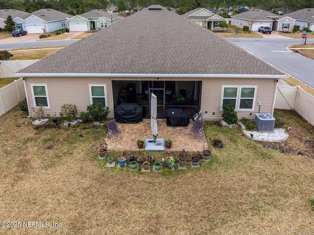 rear view of house featuring a patio, cooling unit, and a lawn