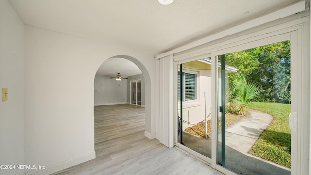 entryway featuring light hardwood / wood-style flooring, ceiling fan, and plenty of natural light