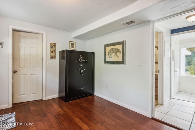 hall featuring wood-type flooring and a textured ceiling