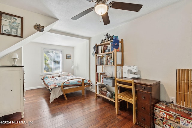 bedroom featuring baseboards, a textured ceiling, wood finished floors, and a ceiling fan