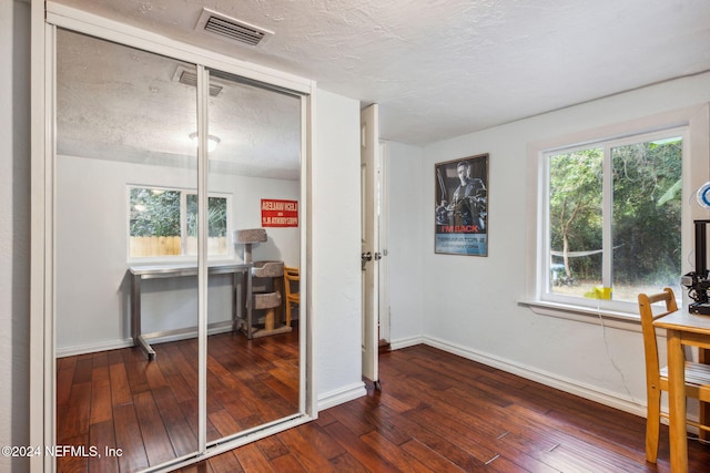 interior space featuring a closet, baseboards, visible vents, and wood-type flooring