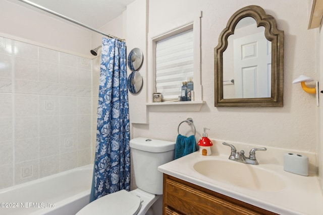 full bathroom featuring shower / bath combo with shower curtain, vanity, and toilet