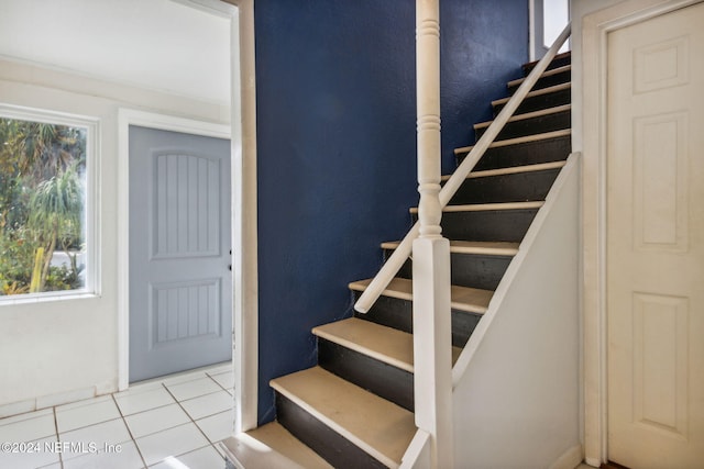 stairs with tile patterned floors