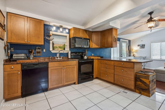 kitchen featuring black appliances, light tile patterned flooring, kitchen peninsula, and vaulted ceiling