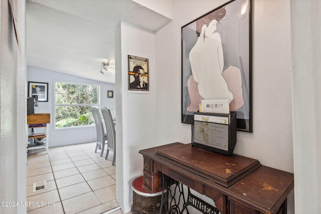 interior space with vaulted ceiling and light tile patterned flooring