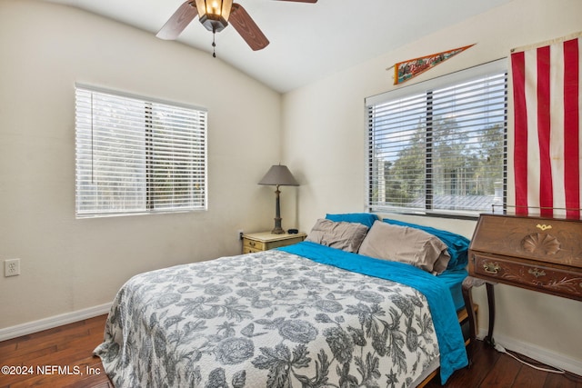 bedroom featuring lofted ceiling, wood finished floors, baseboards, and ceiling fan