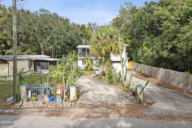 view of front of property with driveway and fence