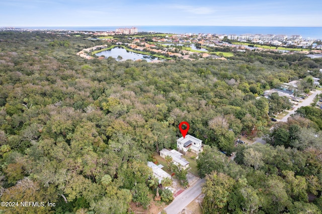 aerial view with a wooded view and a water view