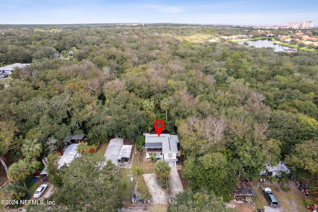 aerial view featuring a forest view and a water view