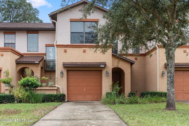 multi unit property featuring a garage