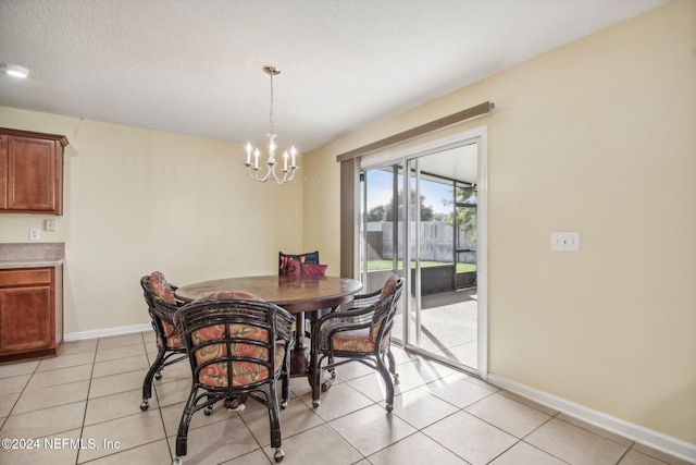 dining space featuring a chandelier, light tile patterned floors, and a textured ceiling