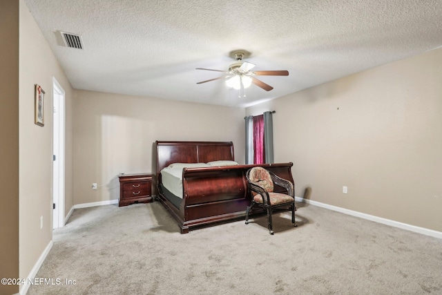 carpeted bedroom with a textured ceiling and ceiling fan