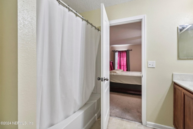 bathroom with vanity, shower / bath combination with curtain, and a textured ceiling