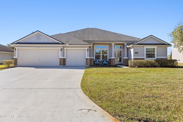 view of front of house with a front yard and a garage