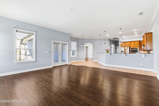 unfurnished living room with light hardwood / wood-style floors and crown molding