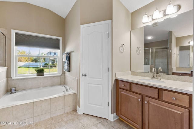 bathroom with tile patterned flooring, vanity, independent shower and bath, and lofted ceiling