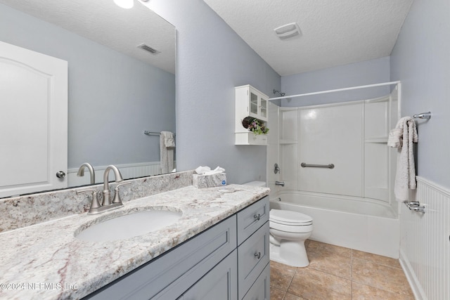 full bathroom featuring tile patterned floors, a textured ceiling, toilet, vanity, and shower / bathtub combination