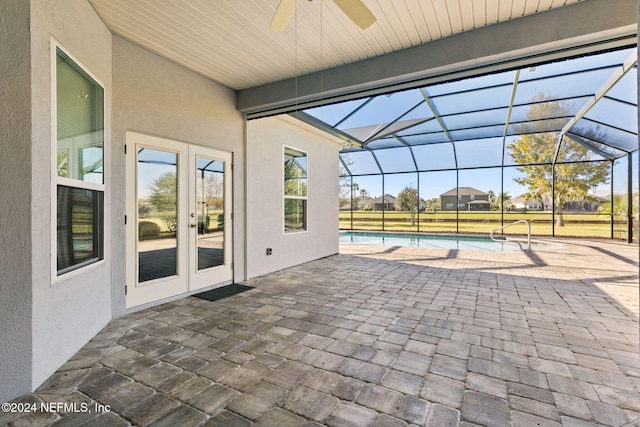 view of patio featuring a lanai, ceiling fan, and french doors