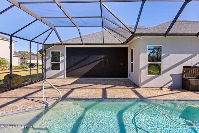 view of swimming pool with a lanai and a patio area