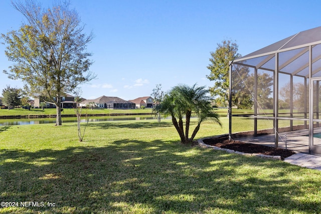 view of yard featuring a water view and a lanai