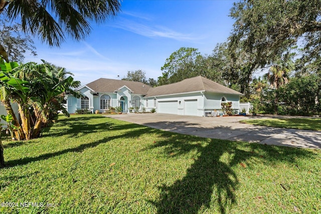 ranch-style home with a garage and a front yard