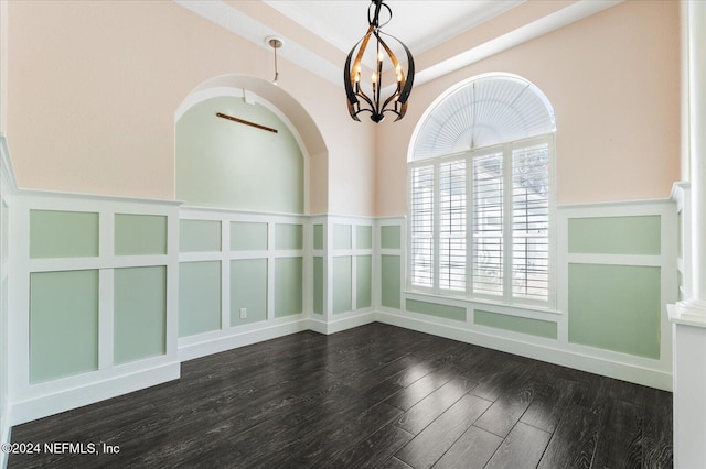 unfurnished room with a notable chandelier and hardwood / wood-style flooring