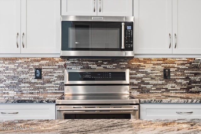 kitchen featuring white cabinets, decorative backsplash, stainless steel appliances, and stone countertops