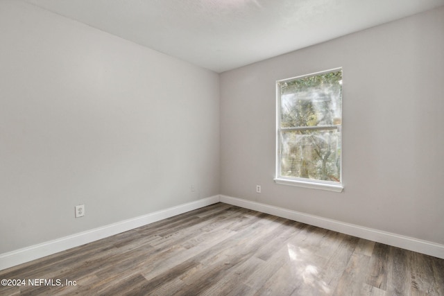 unfurnished room featuring hardwood / wood-style flooring