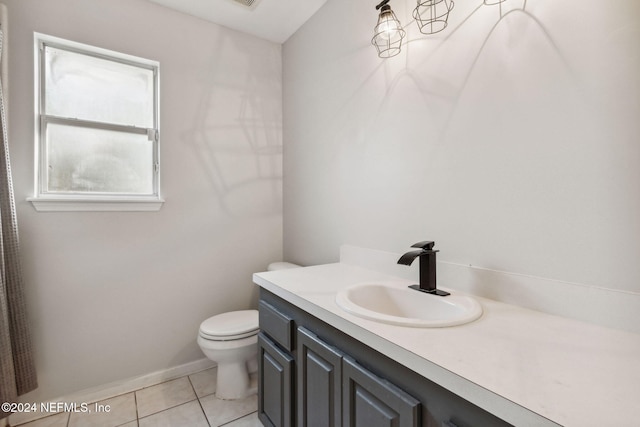 bathroom featuring toilet, vanity, and tile patterned flooring